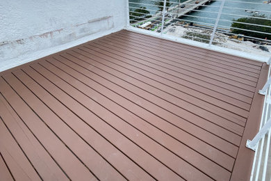 Example of a large island style rooftop rooftop metal railing deck design in Miami with a bbq area and a roof extension
