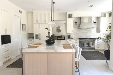 Inspiration for a mid-sized modern l-shaped ceramic tile, white floor and coffered ceiling kitchen pantry remodel in Los Angeles with an undermount sink, shaker cabinets, white cabinets, granite countertops, white backsplash, ceramic backsplash, stainless steel appliances, an island and white countertops