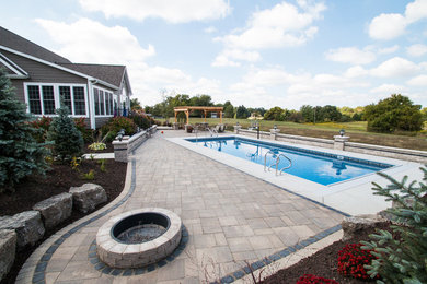 Large transitional backyard concrete paver patio photo in Chicago with a fire pit and a pergola