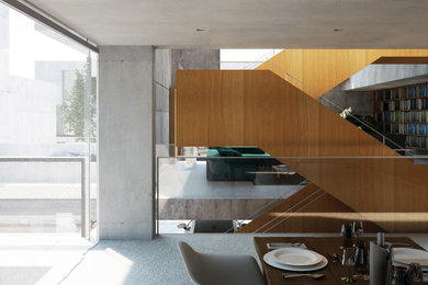 Imagen de comedor de cocina minimalista de tamaño medio sin chimenea con paredes negras, suelo de baldosas de porcelana, suelo gris y madera