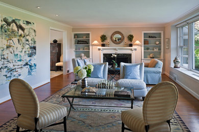 Example of a mid-sized classic open concept medium tone wood floor living room design in San Francisco with beige walls, a standard fireplace, a stone fireplace and no tv