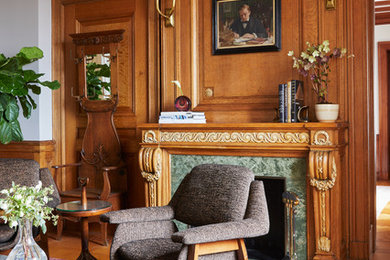 Inspiration for a large timeless formal and enclosed light wood floor living room remodel in Other with a standard fireplace, a stone fireplace, no tv and brown walls