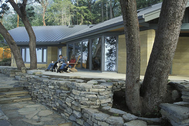 Example of a mid-sized trendy beige one-story exterior home design in Vancouver