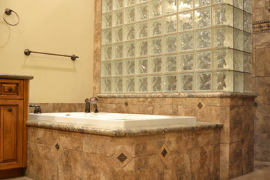 Example of a large classic master porcelain tile bathroom design in Phoenix with raised-panel cabinets, medium tone wood cabinets and granite countertops