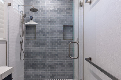 Example of a transitional blue tile and ceramic tile blue floor bathroom design in San Francisco with a hinged shower door and a niche