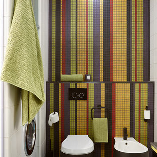 Новый формат декора квартиры: туалет в современном стиле с инсталляцией, разноцветной плиткой, плиткой мозаикой и синим полом