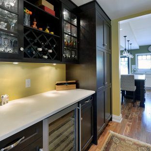 Mid-sized craftsman kitchen pantry designs - Mid-sized arts and crafts single-wall medium tone wood floor kitchen pantry photo in Ottawa with shaker cabinets, dark wood cabinets, quartz countertops, stainless steel appliances and yellow backsplash