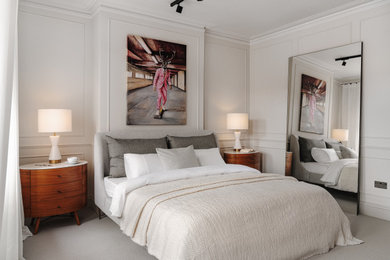 This is an example of a medium sized bohemian formal and grey and brown enclosed living room feature wall in London with white walls, carpet, no tv and wainscoting.
