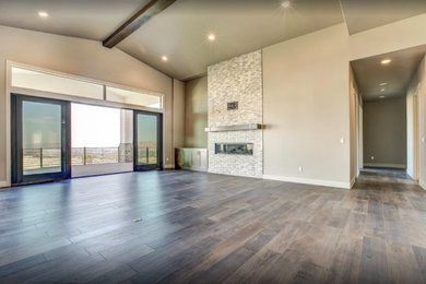 Inspiration for a large transitional formal and open concept dark wood floor and brown floor living room remodel in Other with beige walls, a ribbon fireplace and a stone fireplace