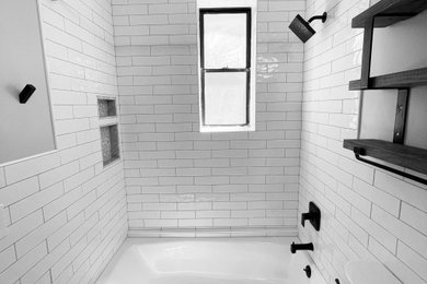 Example of a mid-sized minimalist master white tile and subway tile porcelain tile and black floor bathroom design in New York with a two-piece toilet and white walls