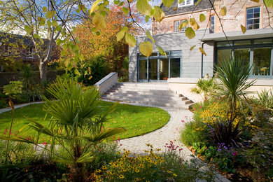 Photo of a large contemporary backyard formal garden in Other with a garden path and natural stone pavers.