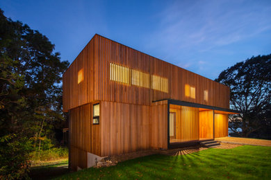 Inspiration for a modern house exterior in Boston with wood cladding.