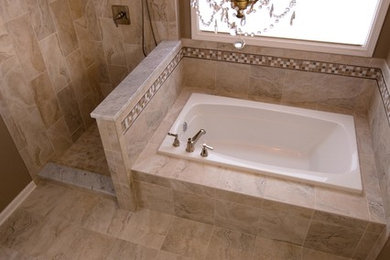Inspiration for a mediterranean bathroom in Chicago with beige tile, mosaic tile and porcelain floors.
