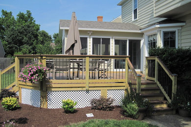 Example of a mid-sized classic backyard deck design in Other with no cover