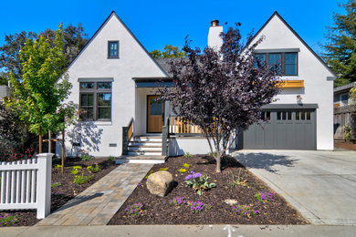 Mid-sized elegant white two-story stucco exterior home photo in San Francisco with a shingle roof and a black roof
