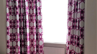 Colourful embroidered curtains on bent track