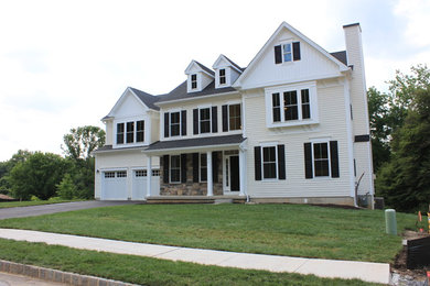 Example of a mid-sized transitional two-story vinyl house exterior design in Philadelphia with a shingle roof