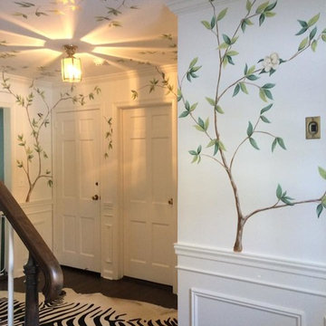 Hand painted tree branches with Magnolia flowers on walls in foyer