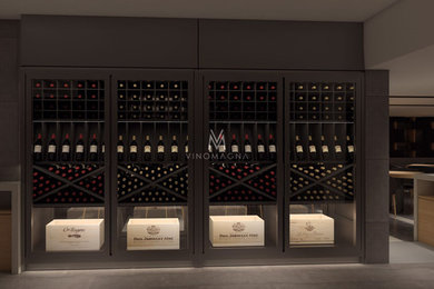 Photo of a large contemporary wine cellar in London with light hardwood floors, display racks and brown floor.