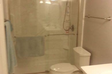 Inspiration for a small timeless master porcelain tile and white floor bathroom remodel in Other with an integrated sink, raised-panel cabinets, white cabinets, solid surface countertops, a two-piece toilet, beige walls and white countertops