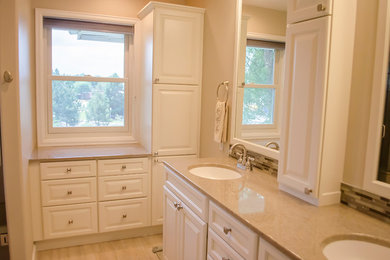 Example of a large transitional master vinyl floor and beige floor bathroom design in Denver with raised-panel cabinets, white cabinets, an integrated sink and onyx countertops