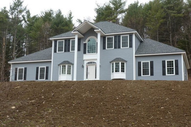 Blue two-story wood exterior home photo in Boston