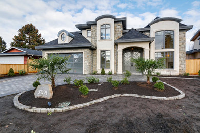 Photo of a transitional two-storey stucco exterior in Vancouver.