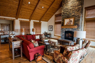 This is an example of a large country open concept living room in Other with white walls, light hardwood floors, a standard fireplace, a stone fireplace surround and no tv.