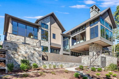 Example of a large trendy brown two-story mixed siding exterior home design in Other with a metal roof and a brown roof