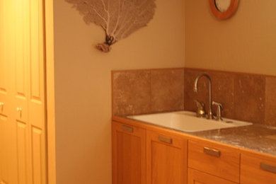 Example of a large transitional master travertine floor and beige floor bathroom design in Other with shaker cabinets, light wood cabinets, beige walls, a drop-in sink, tile countertops and beige countertops