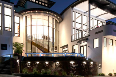 Huge contemporary white two-story stucco exterior home idea in Dallas