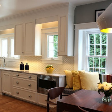 Transitional Kitchen With White Cabinets, Farmhouse Sink, and Quartzite Countert