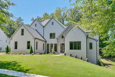 Example of a large gray two-story brick exterior home design in Atlanta with a shingle roof