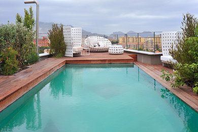 Photo of an industrial rooftop rectangular pool in Catania-Palermo with decking.