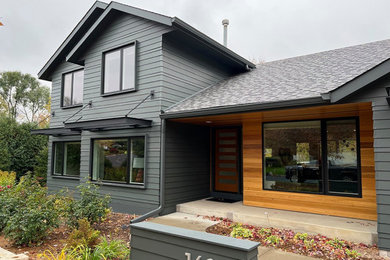 Inspiration for a mid-sized modern blue two-story concrete fiberboard and clapboard exterior home remodel in Minneapolis with a shingle roof and a black roof