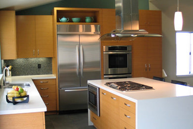 Open concept kitchen - mid-sized contemporary l-shaped porcelain tile and gray floor open concept kitchen idea in Los Angeles with a double-bowl sink, flat-panel cabinets, light wood cabinets, quartz countertops, green backsplash, ceramic backsplash, stainless steel appliances, an island and white countertops