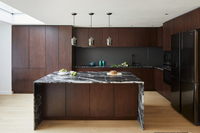 Design ideas for a large contemporary l-shaped kitchen/diner in London with flat-panel cabinets, dark wood cabinets, granite worktops and an island.