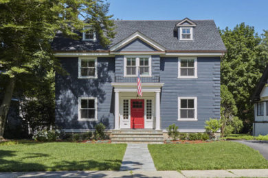 Large elegant blue two-story wood exterior home photo in Boston with a shingle roof