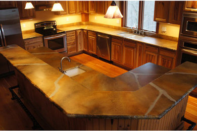 Medium tone wood floor kitchen photo in Other with light wood cabinets, concrete countertops and stainless steel appliances
