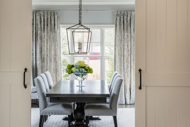 Example of a mid-sized classic dark wood floor and brown floor enclosed dining room design in Boston with gray walls, a standard fireplace and a tile fireplace