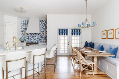 Inspiration for a mid-sized transitional u-shaped medium tone wood floor and brown floor open concept kitchen remodel in Dallas with a drop-in sink, shaker cabinets, white cabinets, quartz countertops, blue backsplash, porcelain backsplash, stainless steel appliances, a peninsula and white countertops