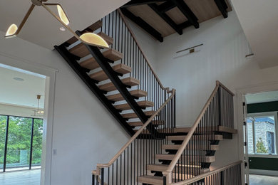 Large minimalist wooden floating mixed material railing and shiplap wall staircase photo in DC Metro