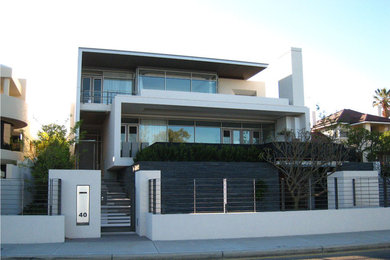 Inspiration for an expansive contemporary three-storey stucco white exterior in Newcastle - Maitland.