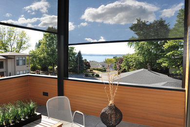 Inspiration for a mid-sized traditional backyard verandah in Seattle with concrete pavers and a roof extension.