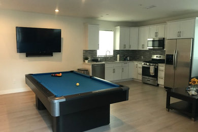 Trendy look-out porcelain tile and beige floor basement photo in Los Angeles with white walls
