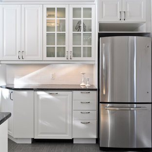 Small transitional kitchen pantry pictures - Kitchen pantry - small transitional l-shaped porcelain floor kitchen pantry idea in Ottawa with a drop-in sink, glass-front cabinets, white cabinets, quartz countertops, white backsplash, subway tile backsplash, stainless steel appliances and no island