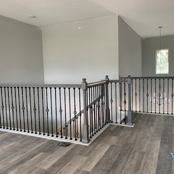 Gray staircase done with basket and double twist iron spindles