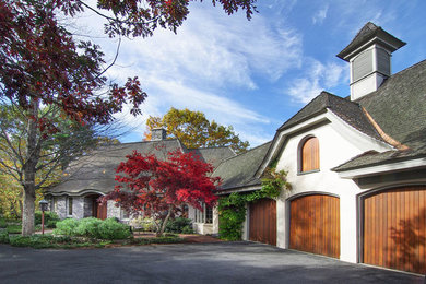 Inspiration for a large timeless beige two-story stucco exterior home remodel in Portland Maine with a shingle roof