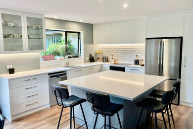 Große Moderne Küche mit Quarzwerkstein-Arbeitsplatte, Küchenrückwand in Weiß, Rückwand aus Porzellanfliesen und weißer Arbeitsplatte in Christchurch