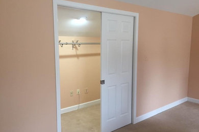 Example of a mid-sized classic carpeted and brown floor walk-in closet design in DC Metro